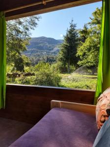 a bedroom with a large window with a view at Riberas del Azul in Lago Puelo