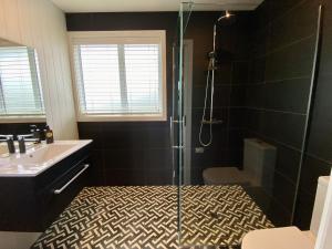 a bathroom with a shower and a sink at Mountain Vista Retreat - Apartment 2 in Twizel +9 photos