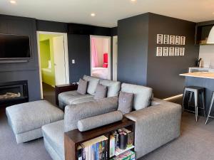 a living room with a couch and a table at Mountain Vista Retreat - Apartment 2 in Twizel