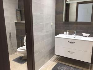 a bathroom with a sink and a toilet at AGADIR BAY - LUXURY APARTMENT NEAR BEACH in Agadir +10 photos