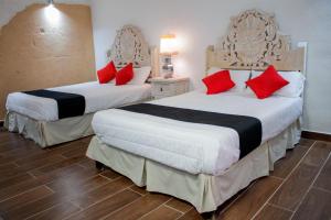 Postel nebo postele na pokoji v ubytování Hotel Boutique Don Porfirio