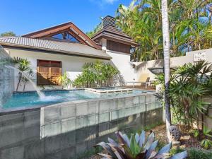 a swimming pool in the backyard of a house at Amala Villa in Byron Bay