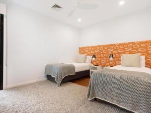 a room with two beds and a rug at Kiah - nestled between Main & Belongil Beaches in Byron Bay +16 photos