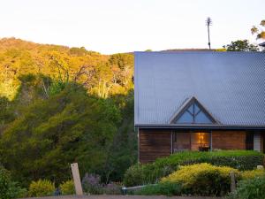 una casa de madera con techo de estaño en una colina en French Cottage- 2 bedrooms with huge spa, en Daylesford