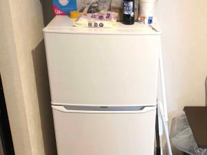 a white refrigerator with a counter on top of it at 民泊 Lokahi海まで徒歩約2分の好立地 敷地内に居酒屋あります in Iioka