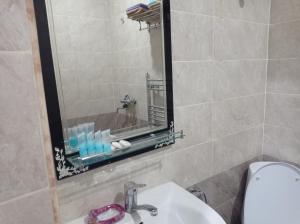 a bathroom with a sink and a mirror at Bizim Ev hostel in Naftalan +8 photos