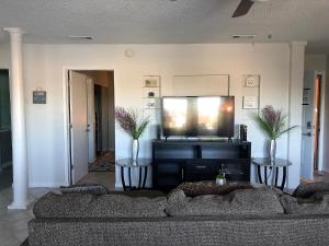 
a living room filled with furniture and a tv at Purple Sunset - Central Destin - 1BR Condo in Destin
