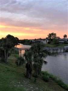
a large body of water with a bridge over it at Purple Sunset - Central Destin - 1BR Condo in Destin
