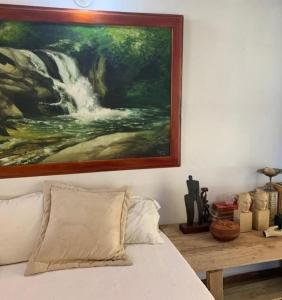 a painting on the wall above a bed in a bedroom at Casa Horizontes in San Carlos