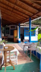 a patio with a table and chairs under a wooden roof at Casa Horizontes in San Carlos +25 photos