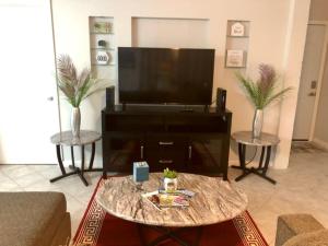 
A television and/or entertainment center at Purple Sunset - Central Destin - 1BR Condo
