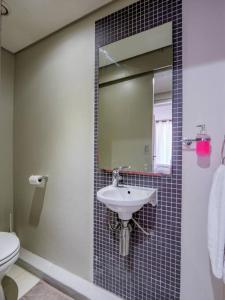 a bathroom with a sink and a mirror at Executive apartment at Ushaka Marine in Durban