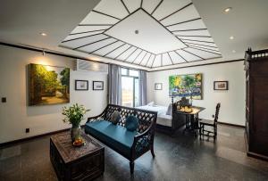 a living room with a couch and a large ceiling at Amanaki Thao Dien in Ho Chi Minh City