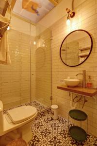 y baño con aseo, lavabo y espejo. en Casa Porta, en Lima