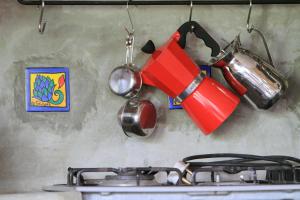 a kitchen with a stove and a pot and utensils at Lands End Kandy in Kandy