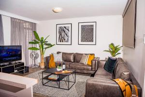 a living room with a couch and a tv at Mulwala Lakeside Apartment in Mulwala
