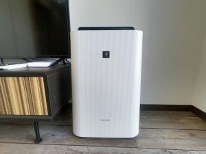 a white refrigerator sitting on the floor next to a desk at rupo green in Ishigaki Island