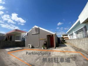 a building with writing on it in a parking lot at rupo green in Ishigaki Island