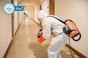 a person in a hallway holding an orange equipment at Northgate Ratchayothin in Bangkok