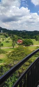 d'un balcon offrant une vue sur un parcours de golf. dans l'établissement Condo D'Savoy A Famosa Resort Melaka Homestay, à Kampong Pulau Sebang
