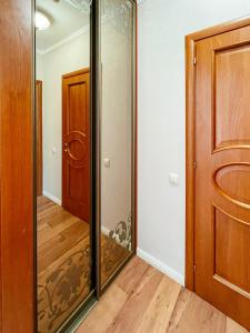 a glass closet in a room with a door at Apart-hotel Arteparts in Krasnoyarsk