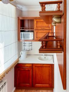 a small kitchen with a sink and a microwave at Apart-hotel Arteparts in Krasnoyarsk