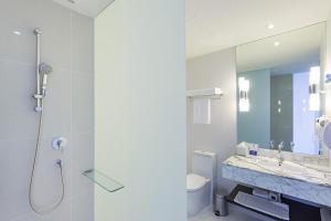 a bathroom with a shower, sink, and toilet at Holiday Inn Express Bangkok Siam, an IHG Hotel - SHA Extra Plus in Bangkok