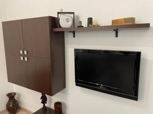 a flat screen tv sitting on top of a wall at Apartament centrul vechi in Baia Mare