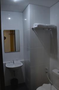a bathroom with a sink and a toilet and a mirror at Hotel 88 Kopo Bandung By WH in Bandung