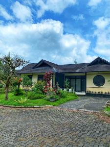 a house with a brick driveway at Designer Villa Osaka in Puncak