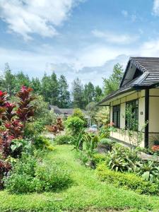 a garden in front of a house at Designer Villa Osaka in Puncak
