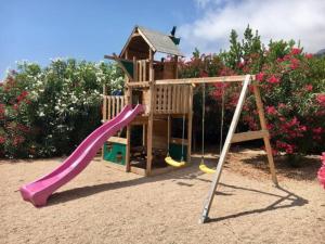 a playground with a slide and a house at Le Clos des Lauriers in Roquebrune-Cap-Martin