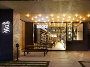a bookstore with lights and a bench in front of it at LAMP LIGHT BOOKS HOTEL fukuoka in Fukuoka