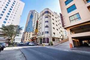 an empty street in a city with tall buildings at OYO 118 Revira Hotel in Manama