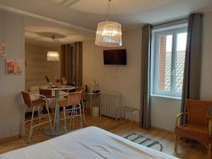 a room with a table and chairs and a dining room at Hotel Restaurant de la Poste in Saint-Just-en-Chevalet