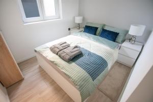 a bedroom with a bed with two towels on it at Flexible SelfCheckIns 27 - Bedroom - NEW in Zagreb