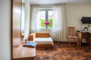 a hotel room with a bed and a window at Hotel Zamek in Giżycko
