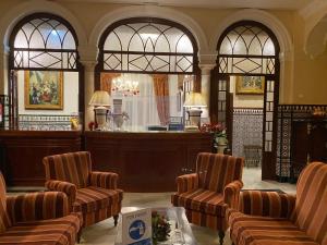 a waiting room with chairs and a bar at Hotel Europa Boutique Sevilla in Seville