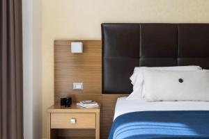 Łóżko lub łóżka w pokoju w obiekcie Aqua Hotel