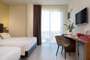 Łóżko lub łóżka w pokoju w obiekcie Aqua Hotel