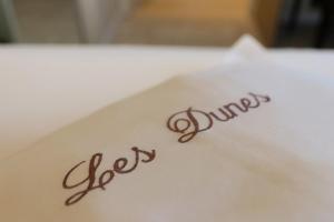 a close up of the word dirt on a plate at Hotel Les Dunes in De Haan