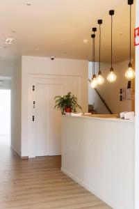 a lobby with a counter and a door at Hotel Les Dunes in De Haan