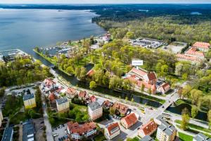 an aerial view of a town next to the water at Hotel Zamek in Giżycko