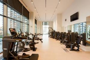a gym with a row of treadmills and ellipticals at Queen Apartments Belgrade Waterfront in Belgrade