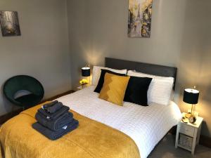 a bedroom with a bed with a bag on it at Moss Cottage in Willaston