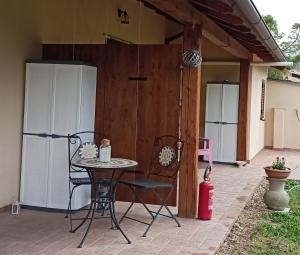 a patio with a table and chairs and a fence at Residence Grimani in Stroncone +69 photos