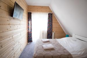 een kleine slaapkamer met een bed en een raam bij Admi Zakopane in Zakopane