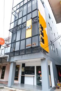 a building with a yellow and black facade at M Cabin Karawaci in Binong