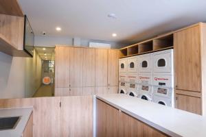 a kitchen with wooden cabinets and white appliances at M Cabin Karawaci in Binong