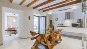 a kitchen with a table made out of wood at Number 11 in Pollença